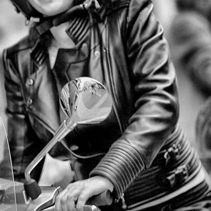 Woman_in_leather_jacket_on_Vespa,_Antwerp_Belgium